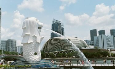 white concrete statue near city buildings during daytime